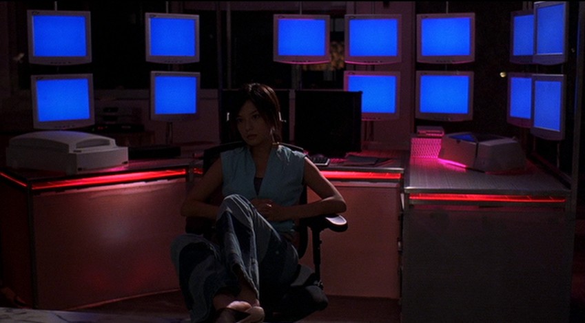 Sue in front of her blue monitors