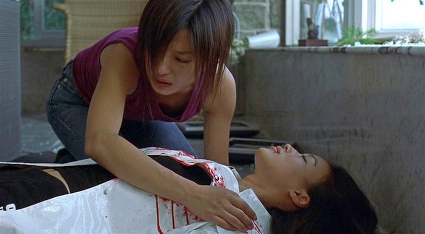 Sue kneels by Lynn's body